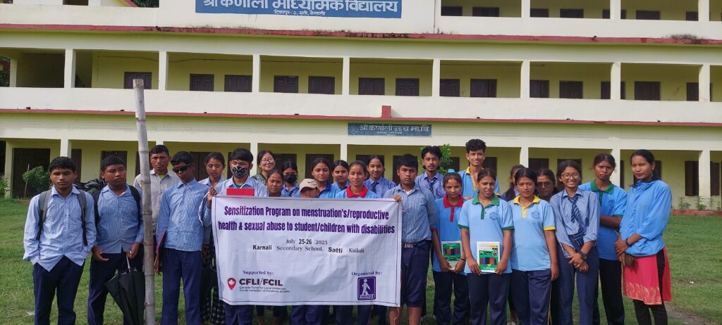 a group of students holding a banner infront of their school