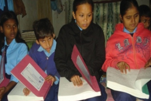 Visually impaired students reading their braille books