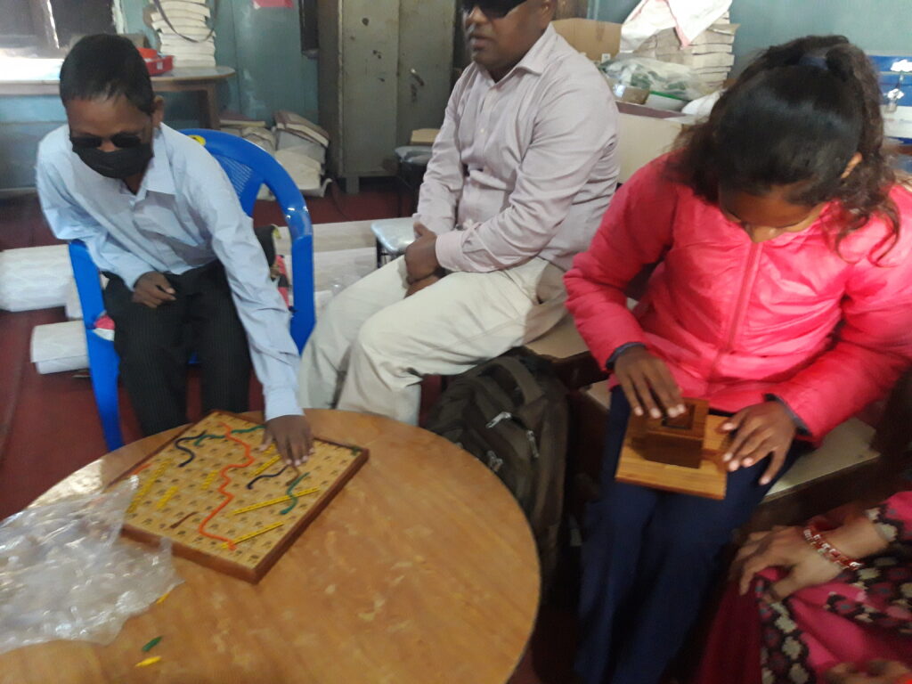The blind students learning snakes and ladder at tribhuban sec school Banke.
